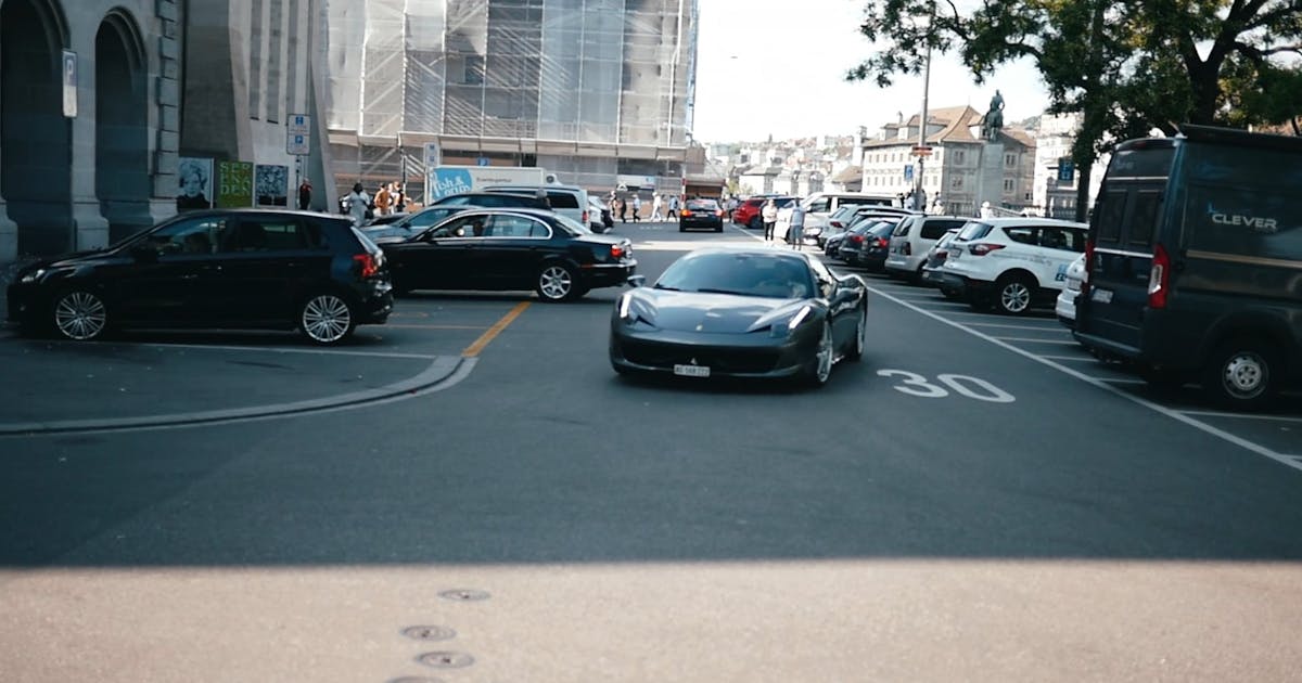 Ferrari driving down a city street