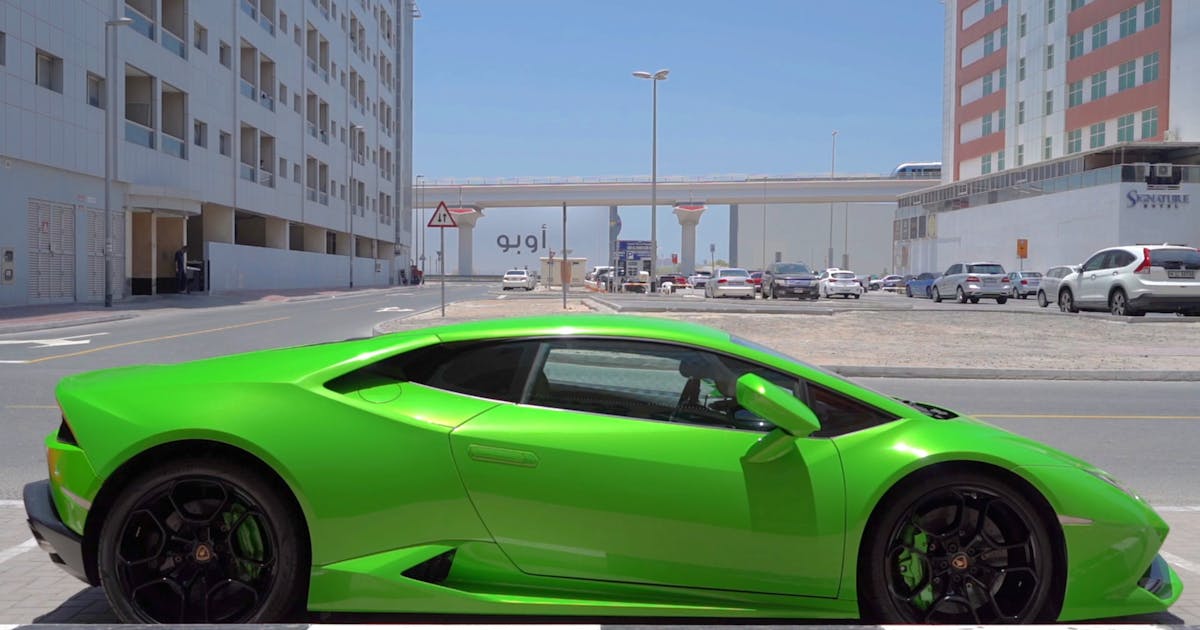 Green Lamborghini Huracán parked on a city street